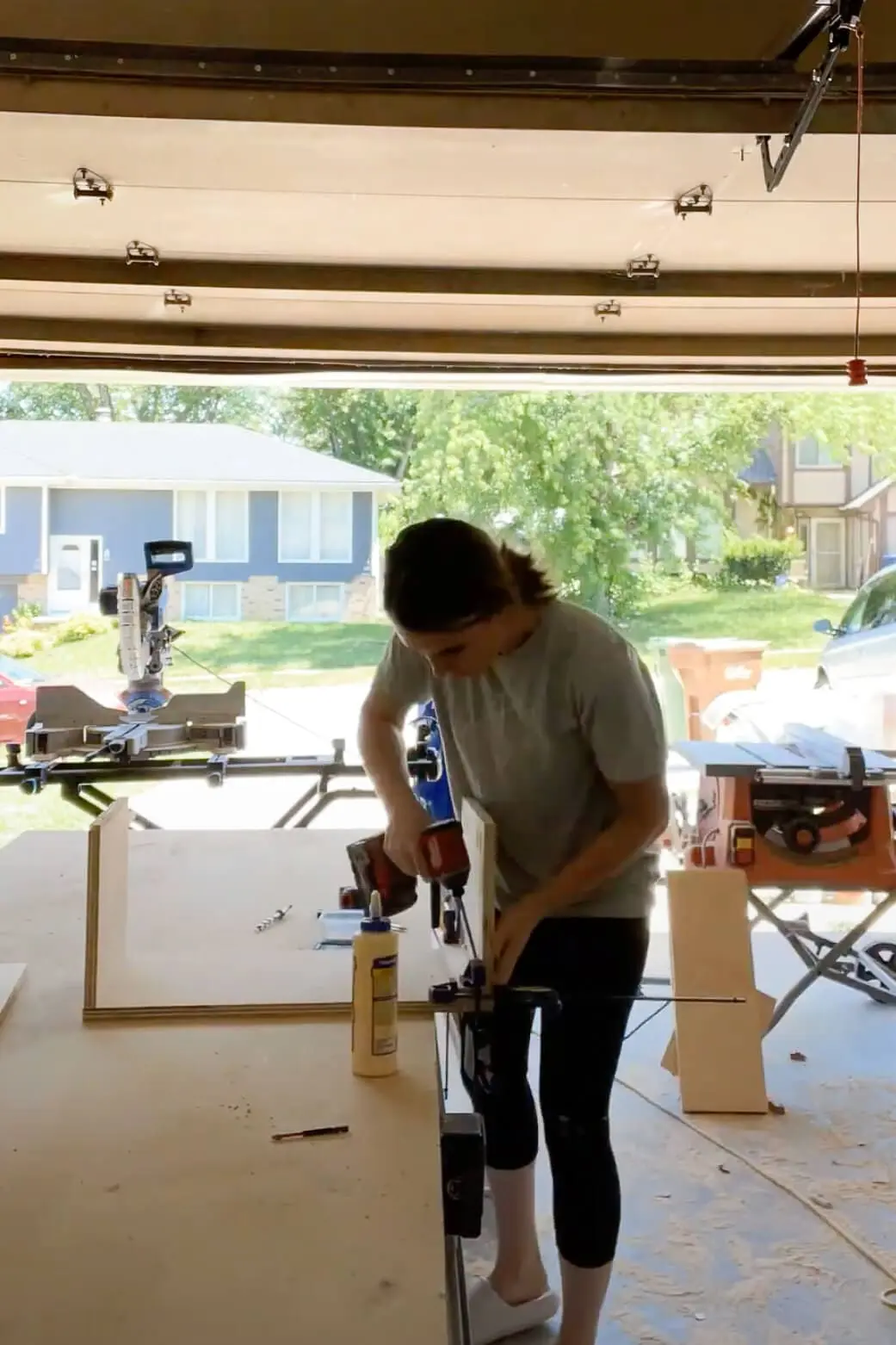 Woman building cabinet box for extending kitchen cabinets to the ceiling.