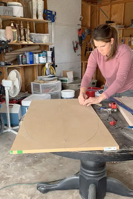 Woman using the nail and string method to draw an oval