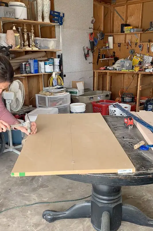 Woman drawing an oval on MDF