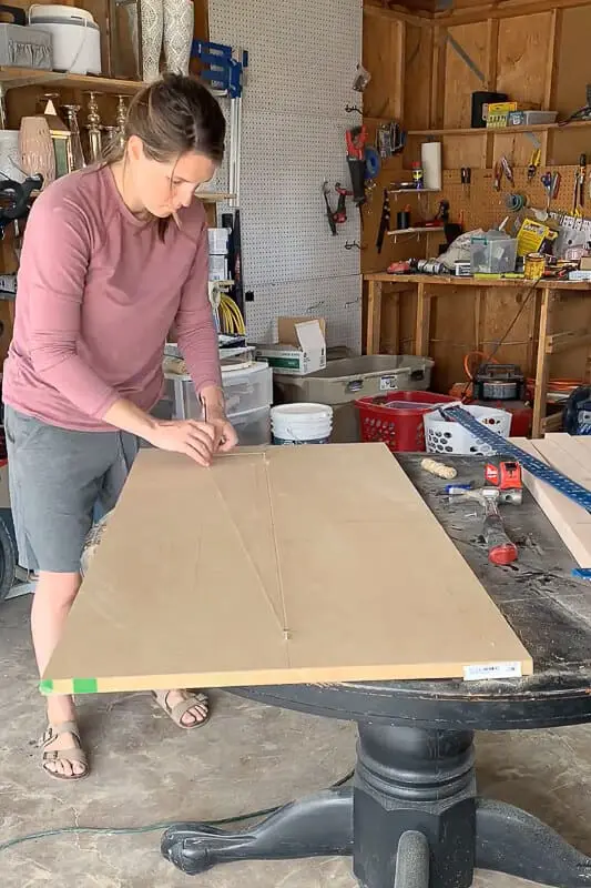 Woman using the string and nail method to draw an oval