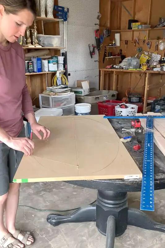 Woman using the nail and string method to draw an oval
