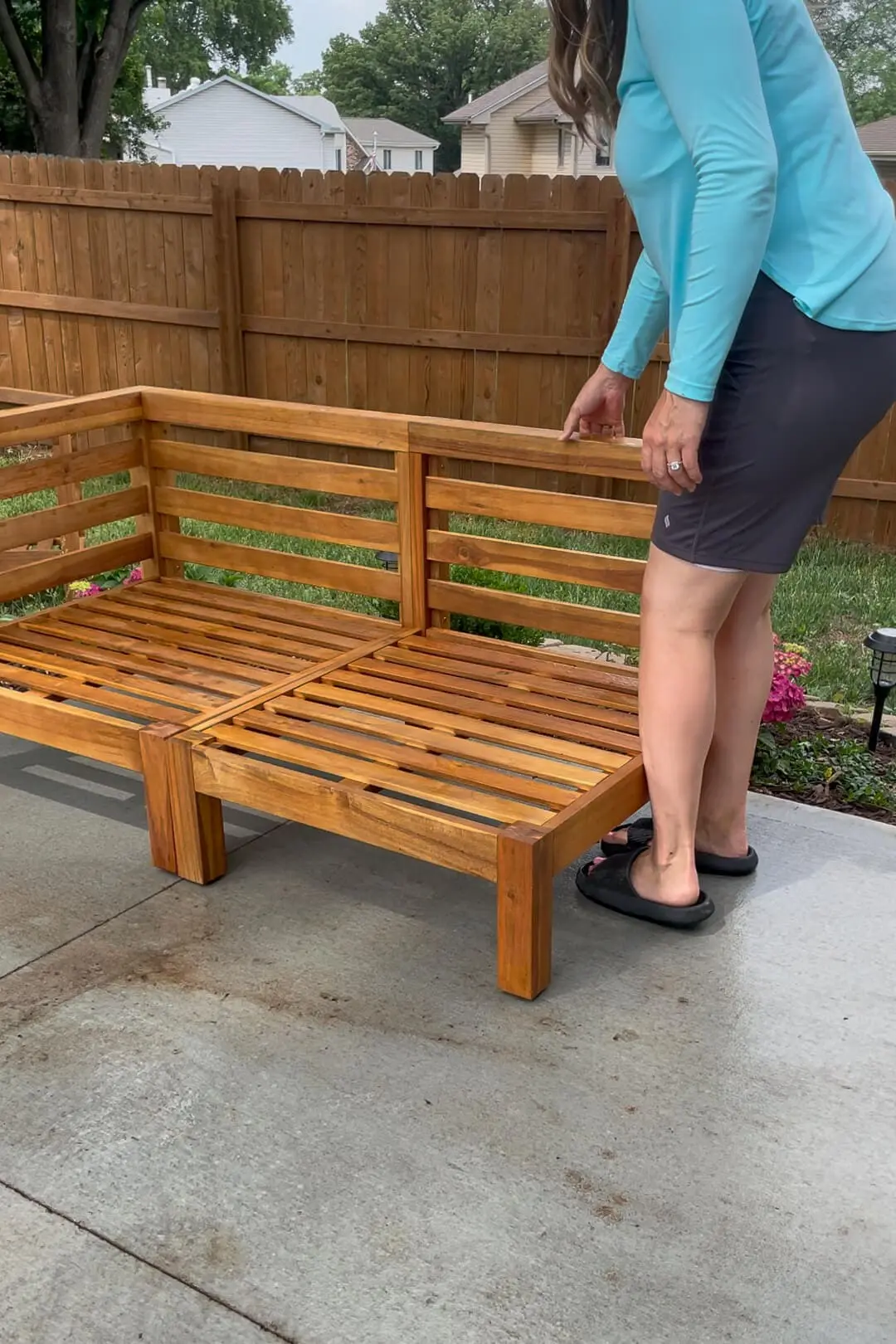 Setting up an outdoor sectional on a backyard patio.