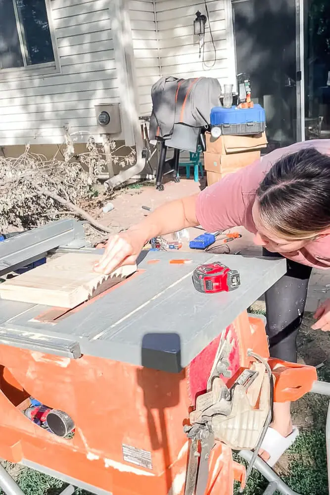 woman cutting wood for a knife block