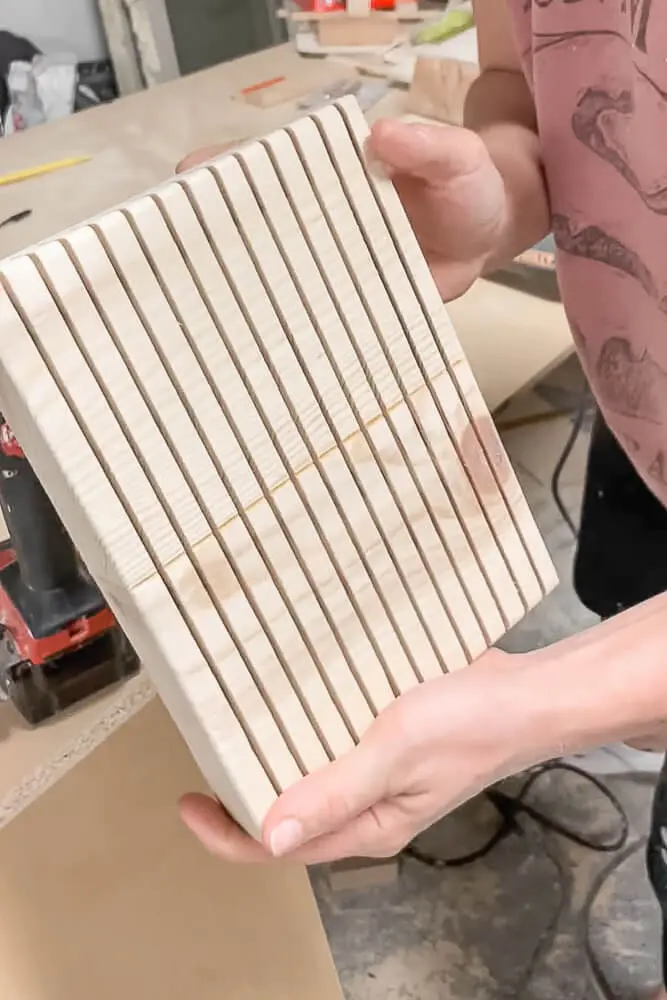 woman showing her in drawer knife block