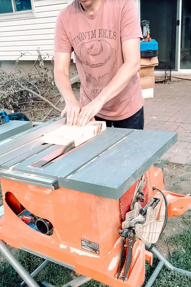 woman cutting wood for a knife block