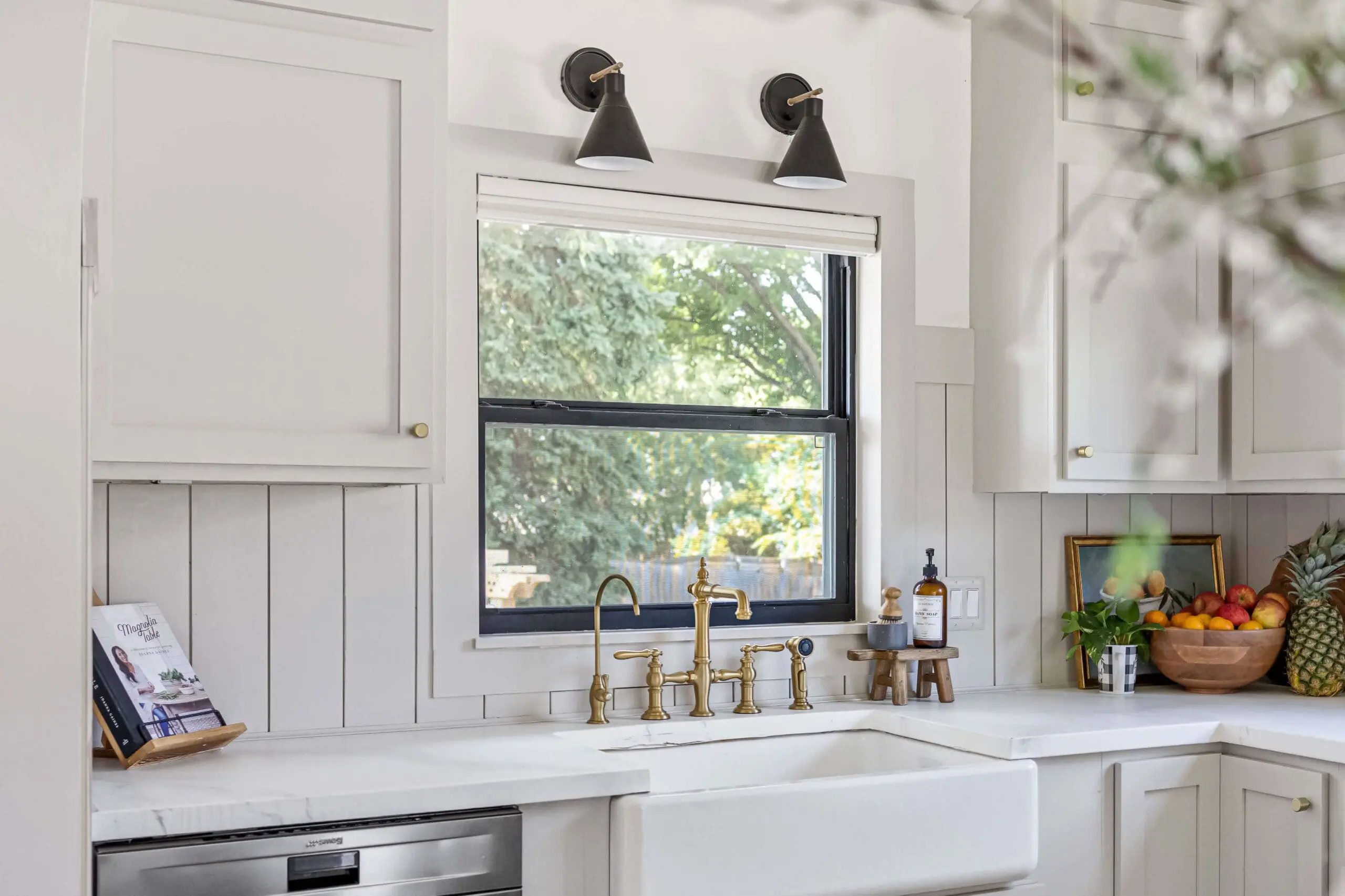 Painting window frames black using spray paint for a low cost DIY project.