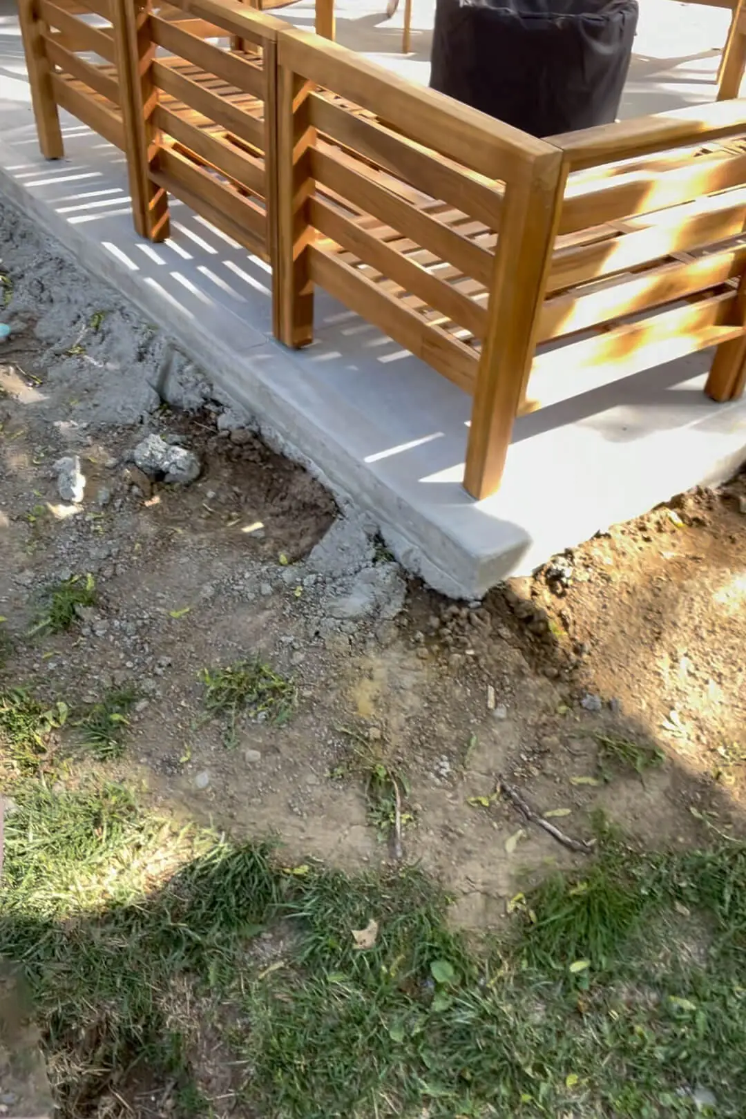 Edge of patio is unfinished and in need of landscaping.