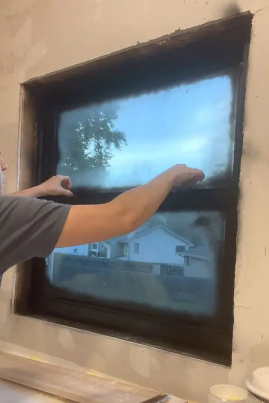 Spray painting window latches to match the frames.