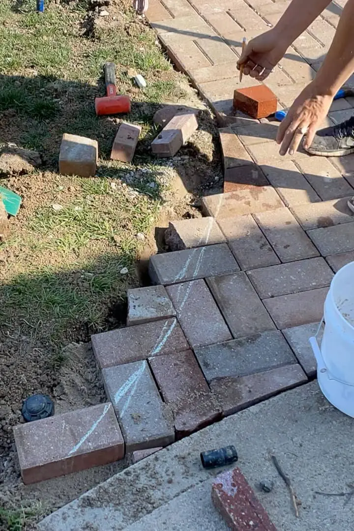 Using chalk to roughly mark where I will curve my paver driveway.