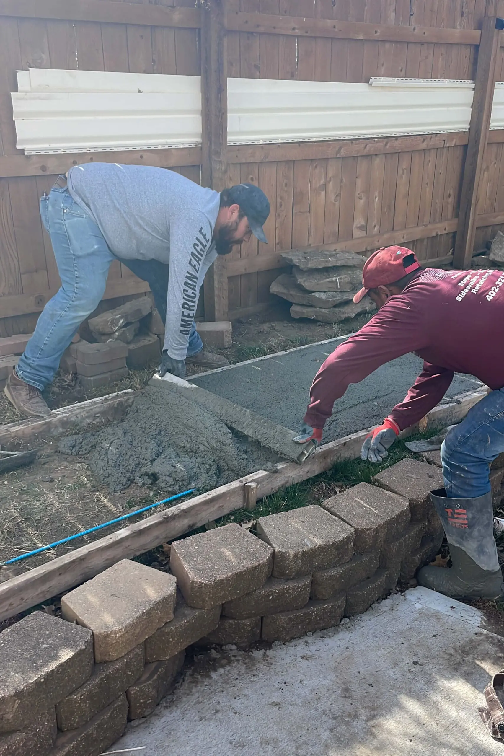 Spreading concrete to fill forms. 