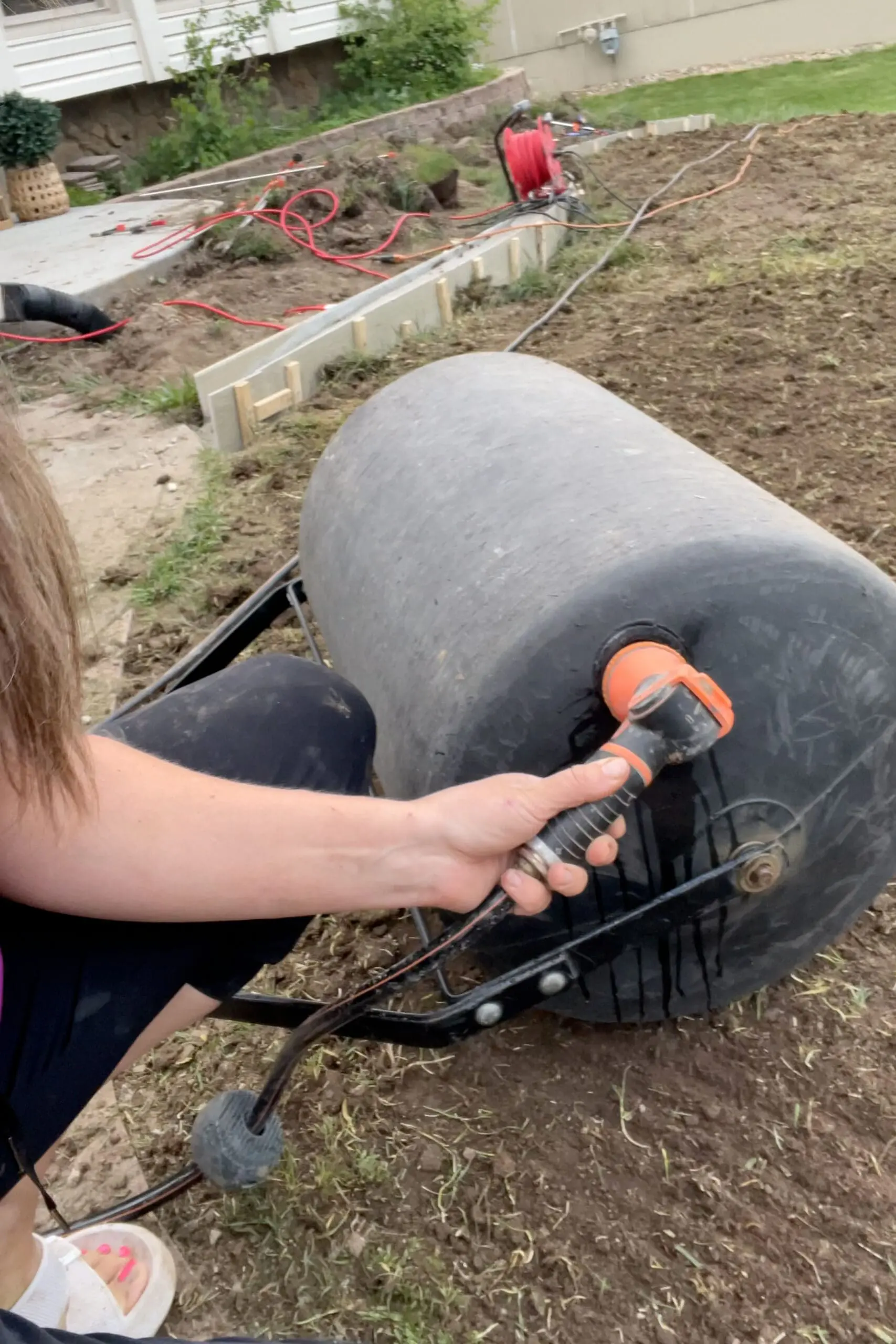 Using a lawn roller to prep for laying sod. 