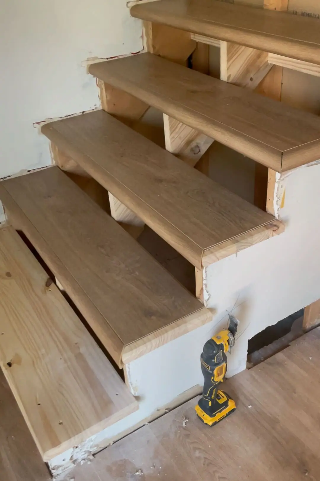 Adding flooring to staircase.
