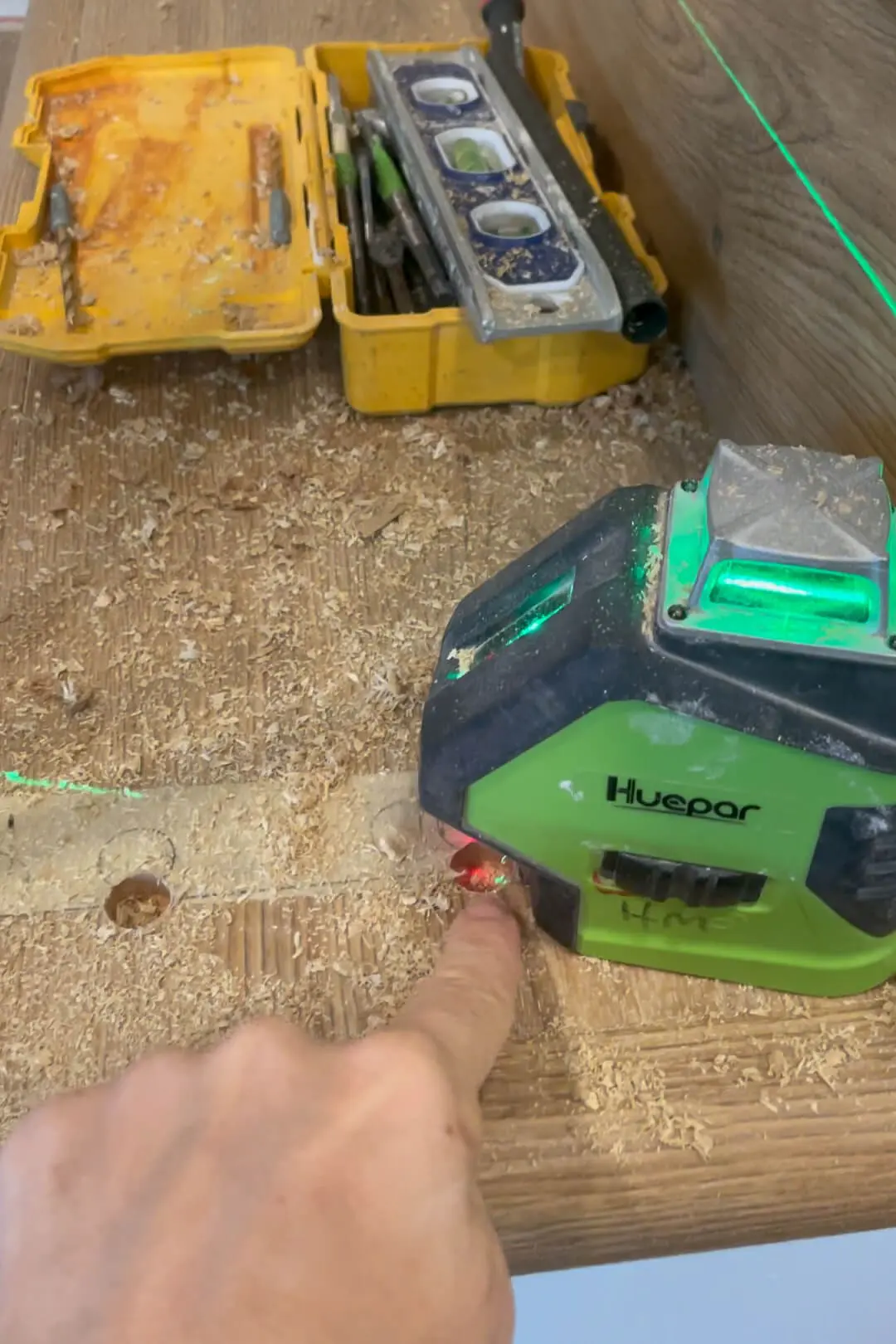 Using a laser level to install balusters in a staircase.