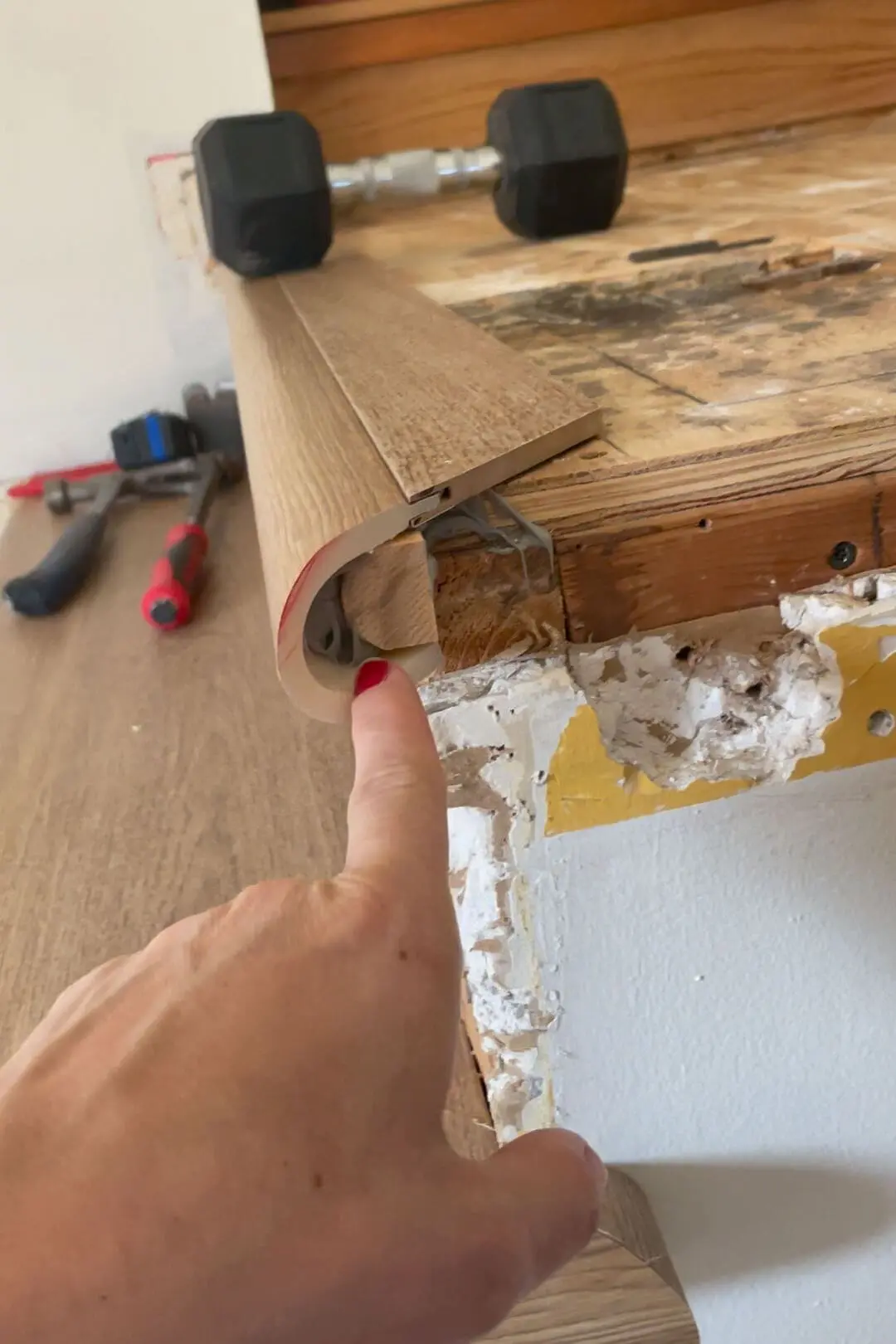 Installing flooring on a staircase.