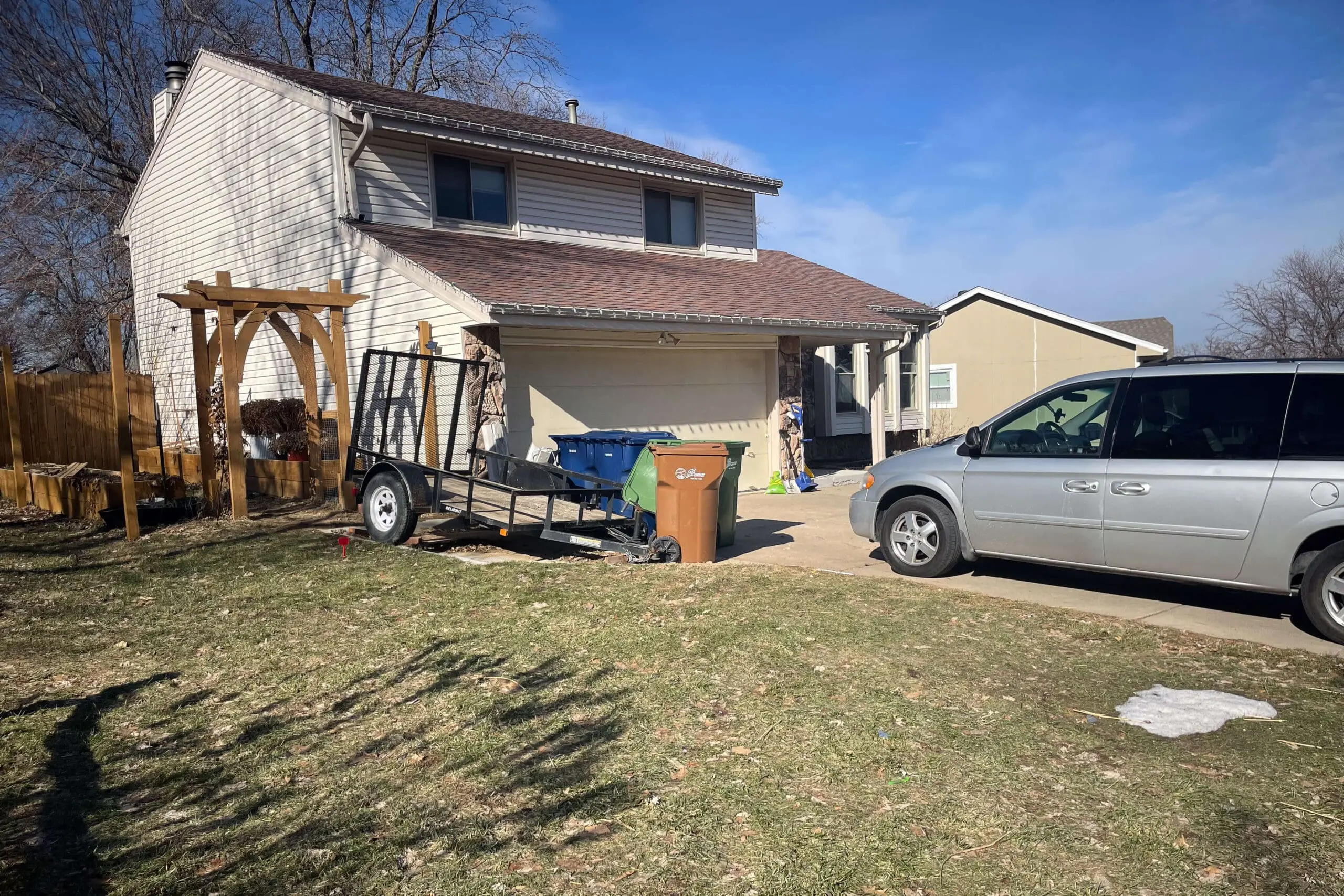 Ugly trailer parking in front of beautiful side yard, ruining the view and curb appeal.
