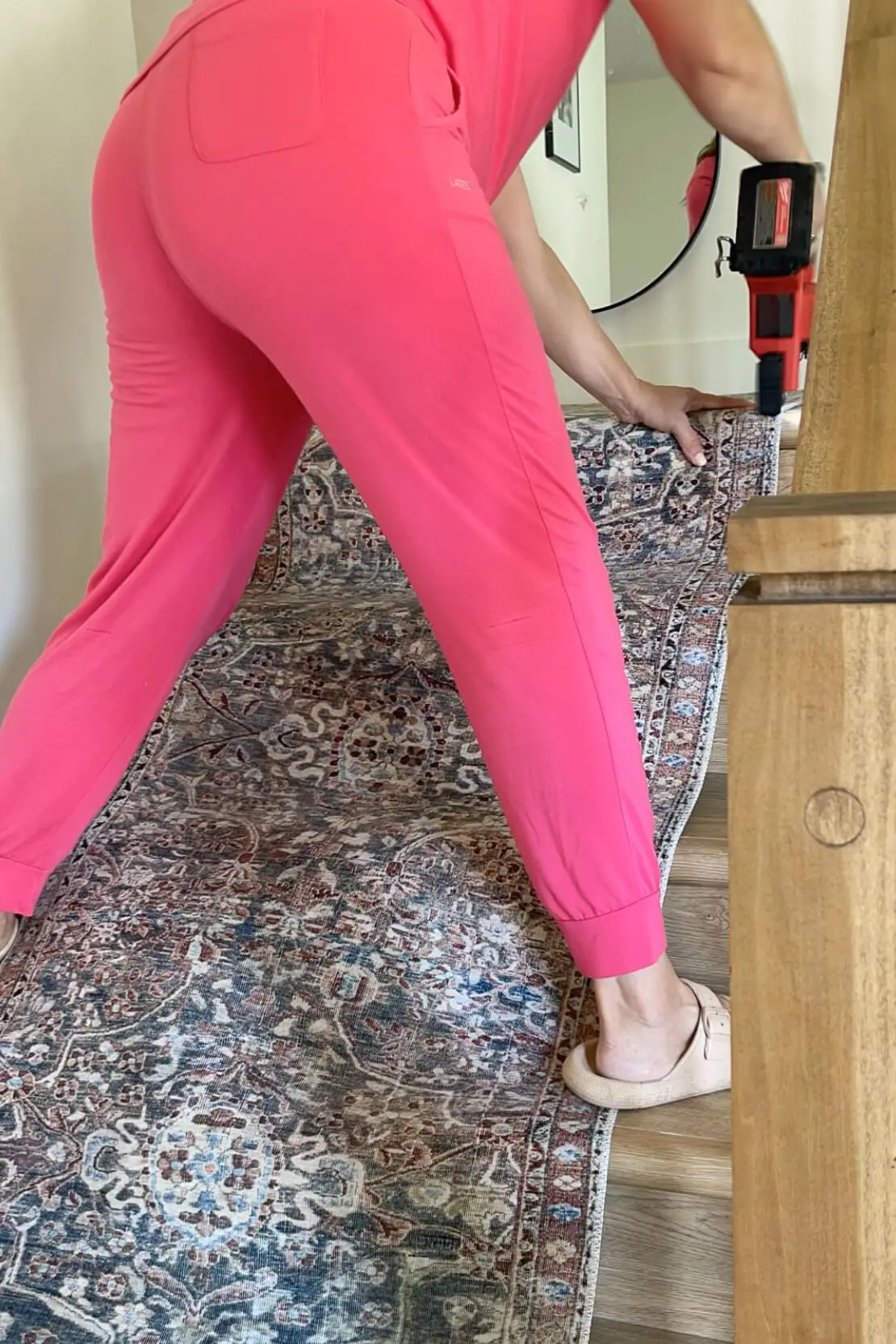 Stapling a stair runner to stairs.