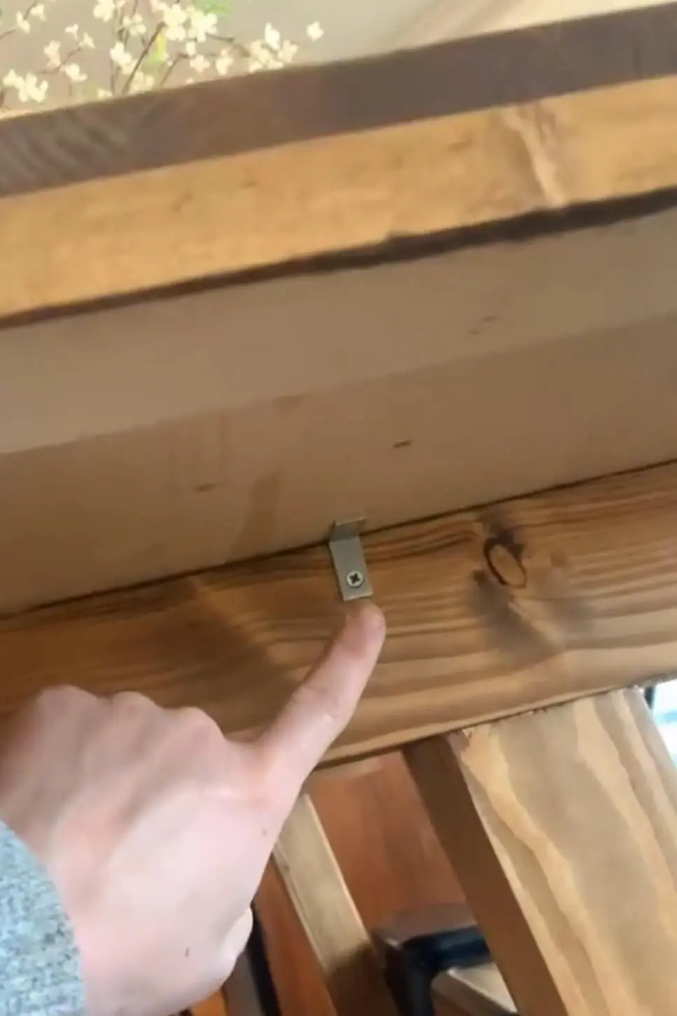 Attaching a table top to its base with angle brackets.