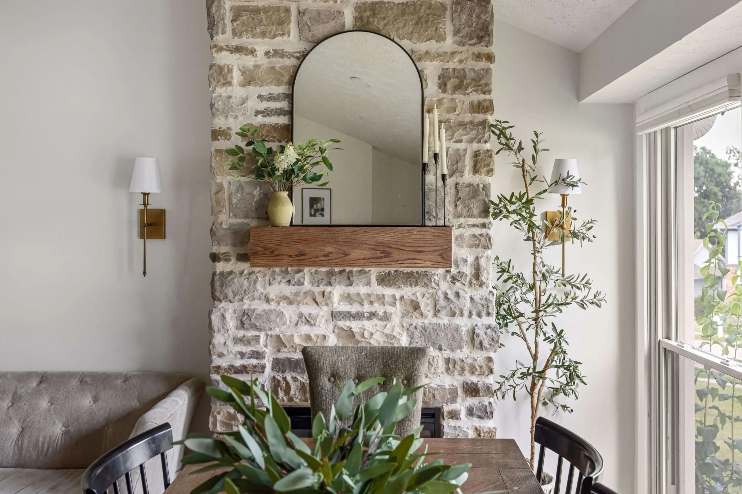 How to build a DIY floor-to-ceiling stone fireplace with a custom oak mantel as a stunning focal point in the dining room.