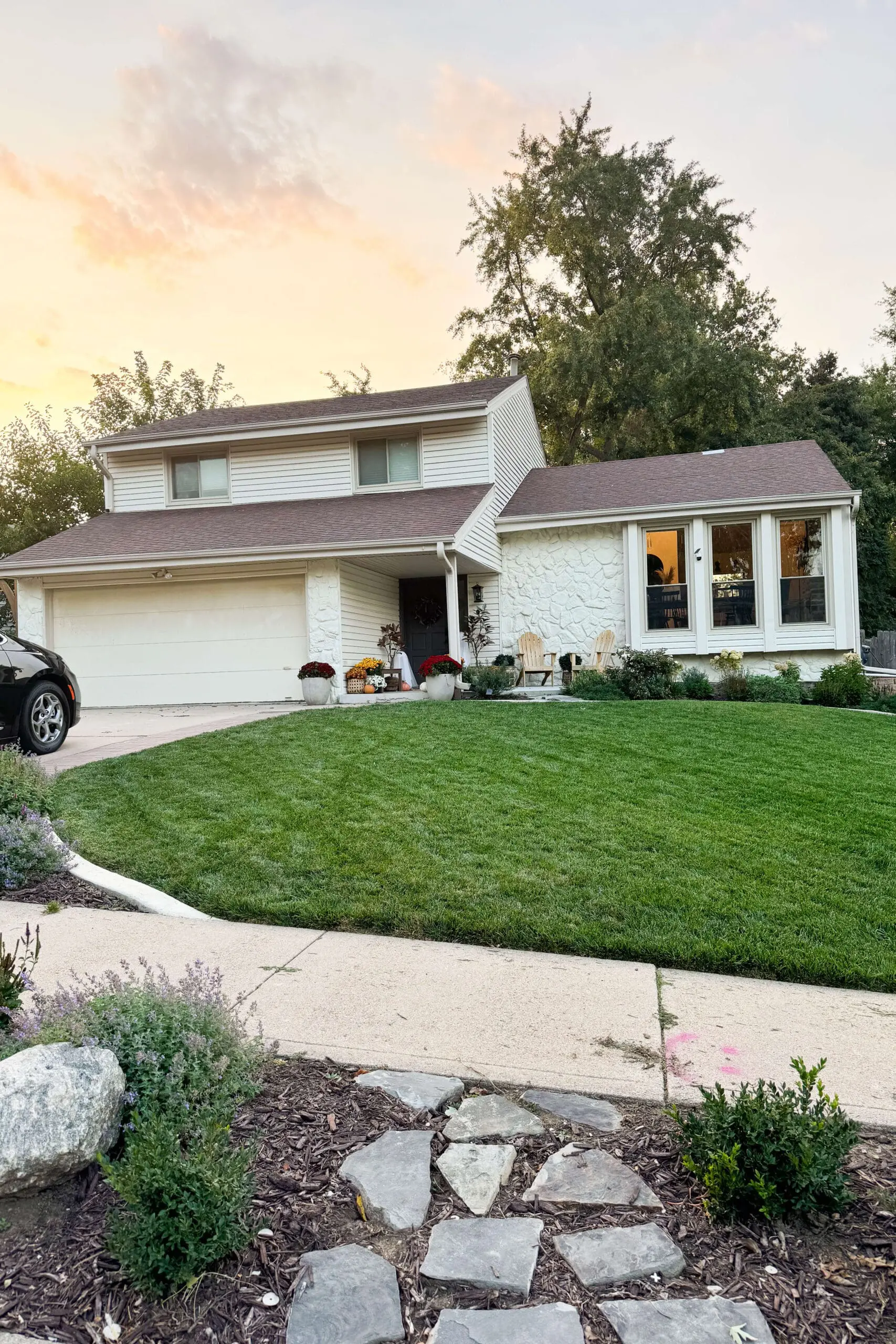 Updated home exterior with new sod, new landscaping, painted rock, and more.