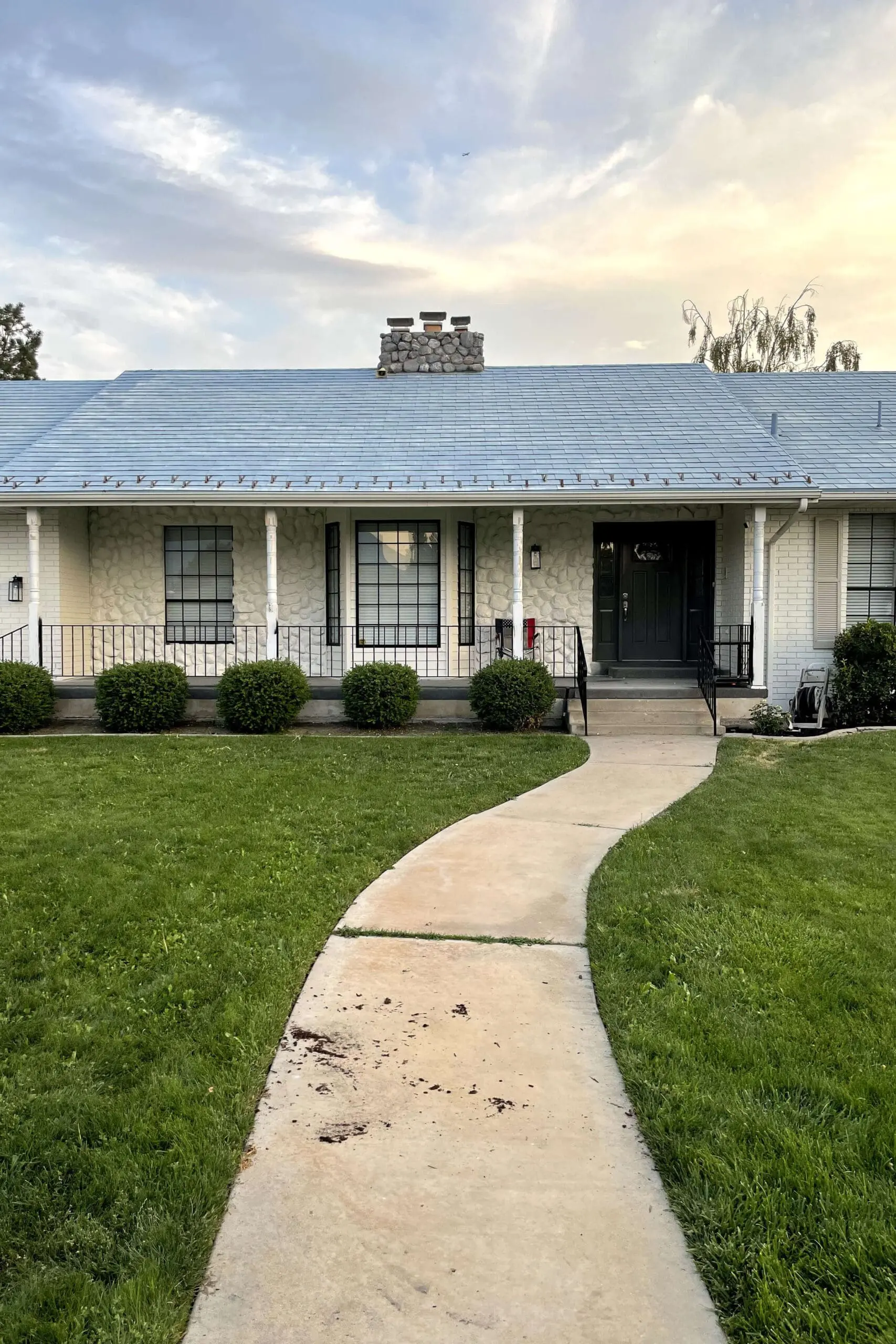  Front porch view showing updated black window grids as part of an in-progress photo exterior refresh.