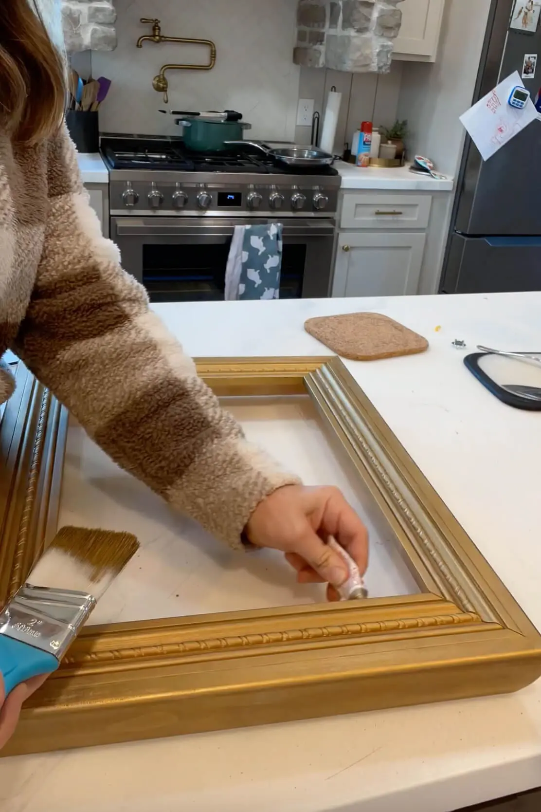 Painting and detailing a DIY gold frame for a custom canvas gift idea for Father’s Day.