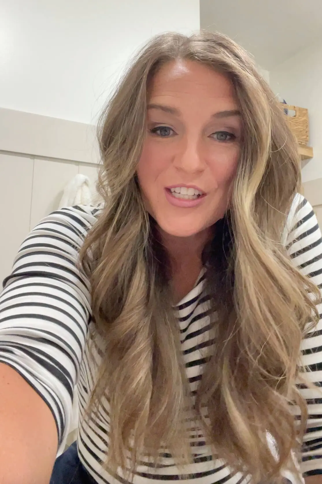 Finished look of long hair with soft, voluminous waves showing off freshly cut layers.