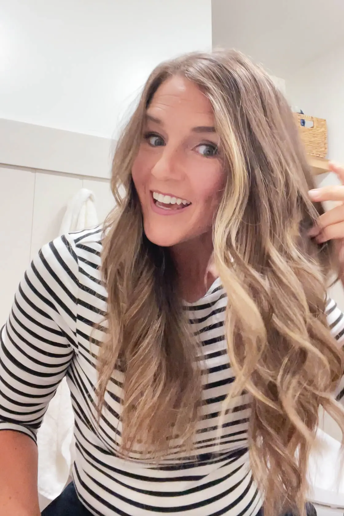 Close-up of long, curled hair showing soft layers after a DIY at-home haircut.