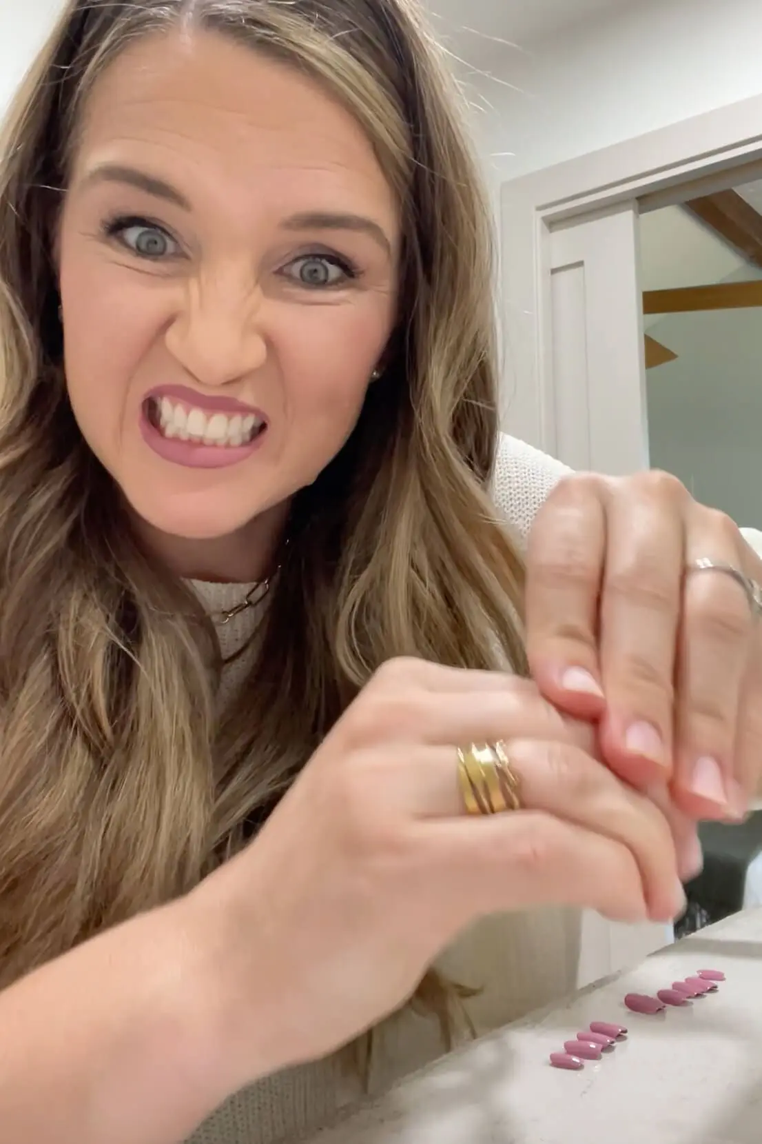 Firmly pressing down to secure the Kiss Impress nails in place for long-lasting wear.

