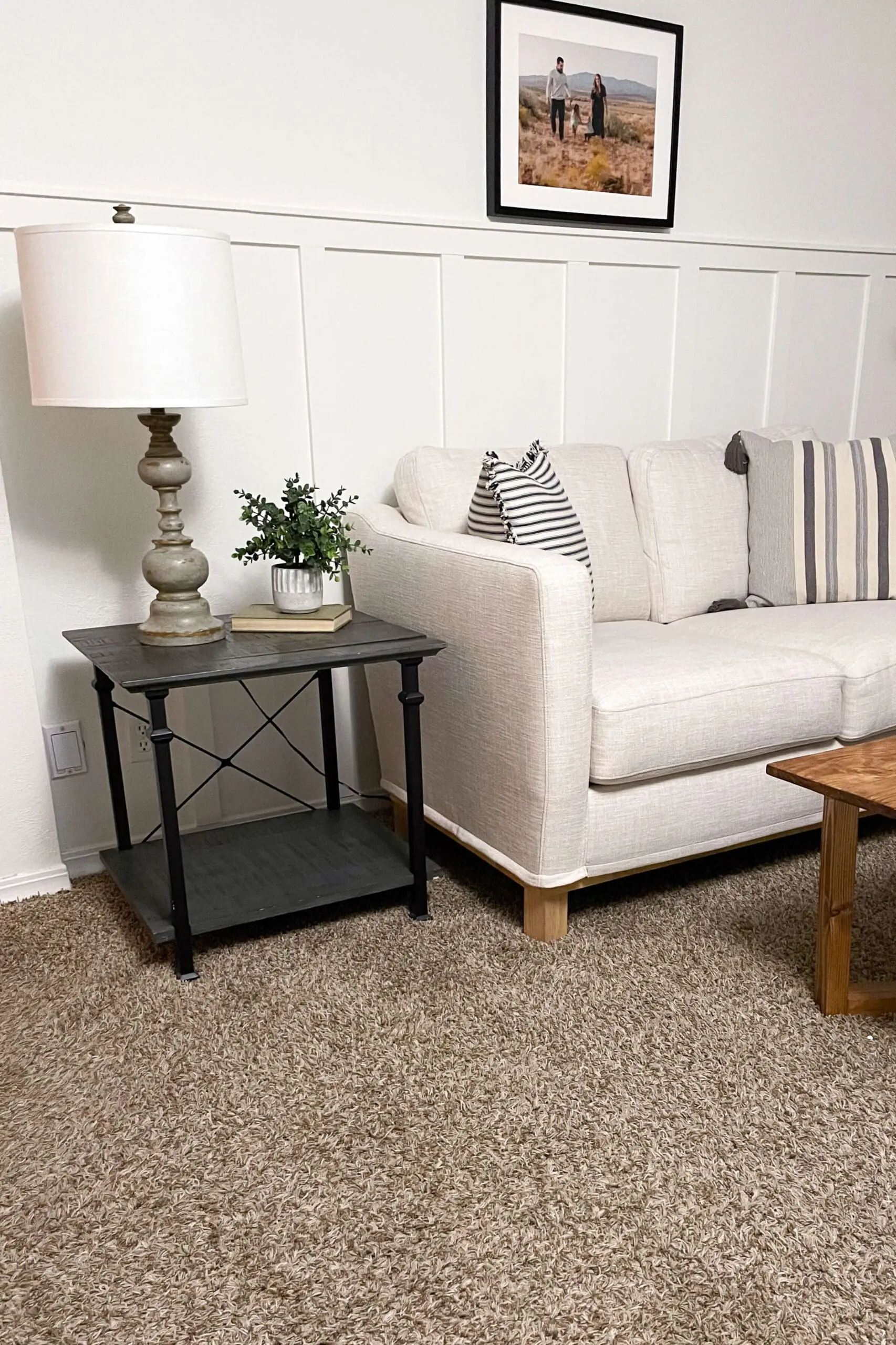 Cozy living room showcasing a simple DIY accent wall with vertical battens, paired with a farmhouse-style side table and neutral decor.