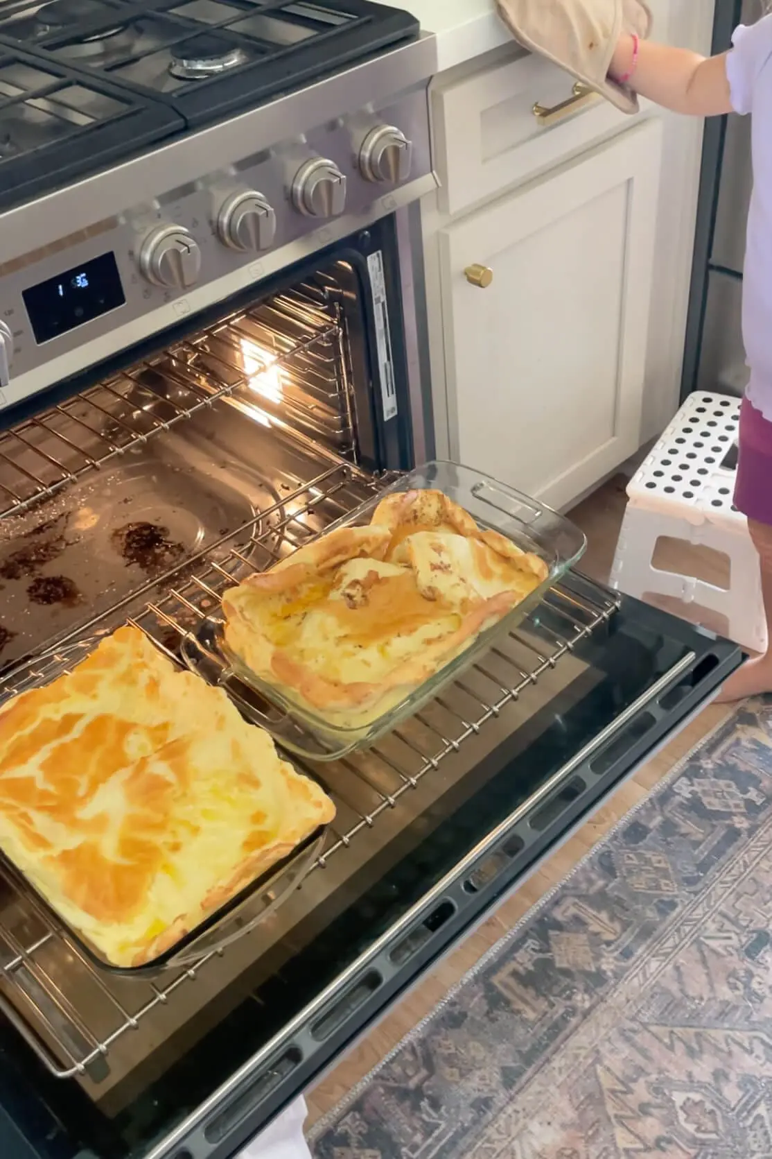 wo freshly baked golden German Pancakes puffed up in the oven, still on the rack.