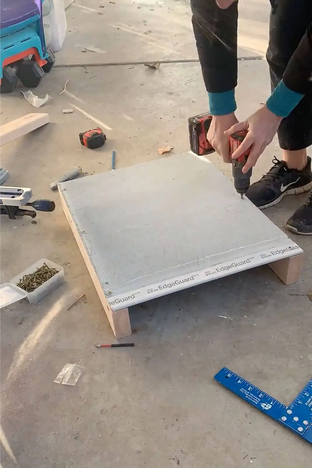 Attaching cement backer board to the framed shower niche before installing it into the wall.