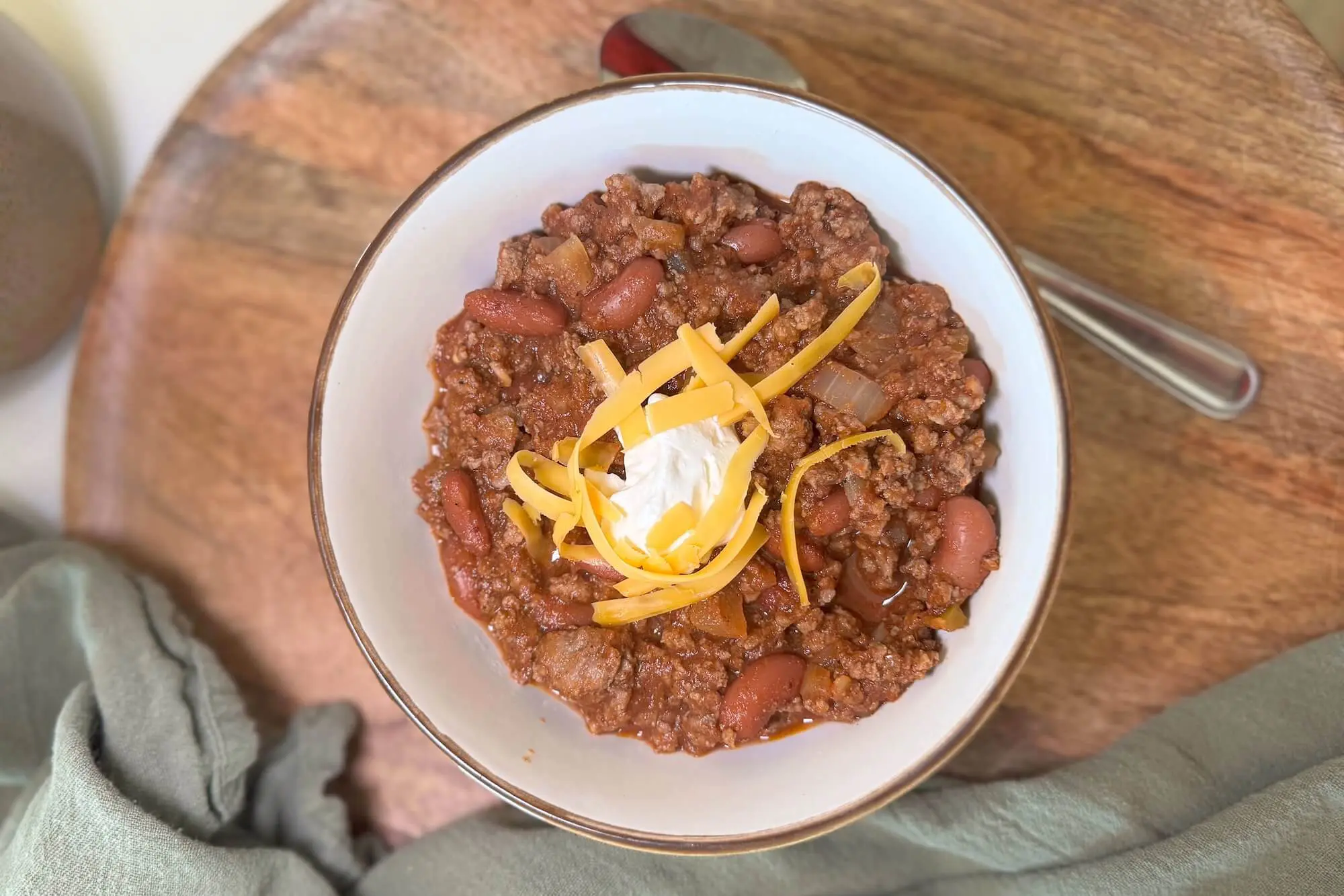 Classic beef and bean chili topped with shredded cheese and sour cream — perfect for football Sunday gatherings.
