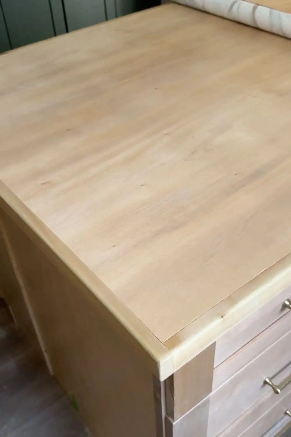 Plywood kitchen island countertop sanded, sealed, and ready for marble contact paper application in a DIY faux marble counter project.