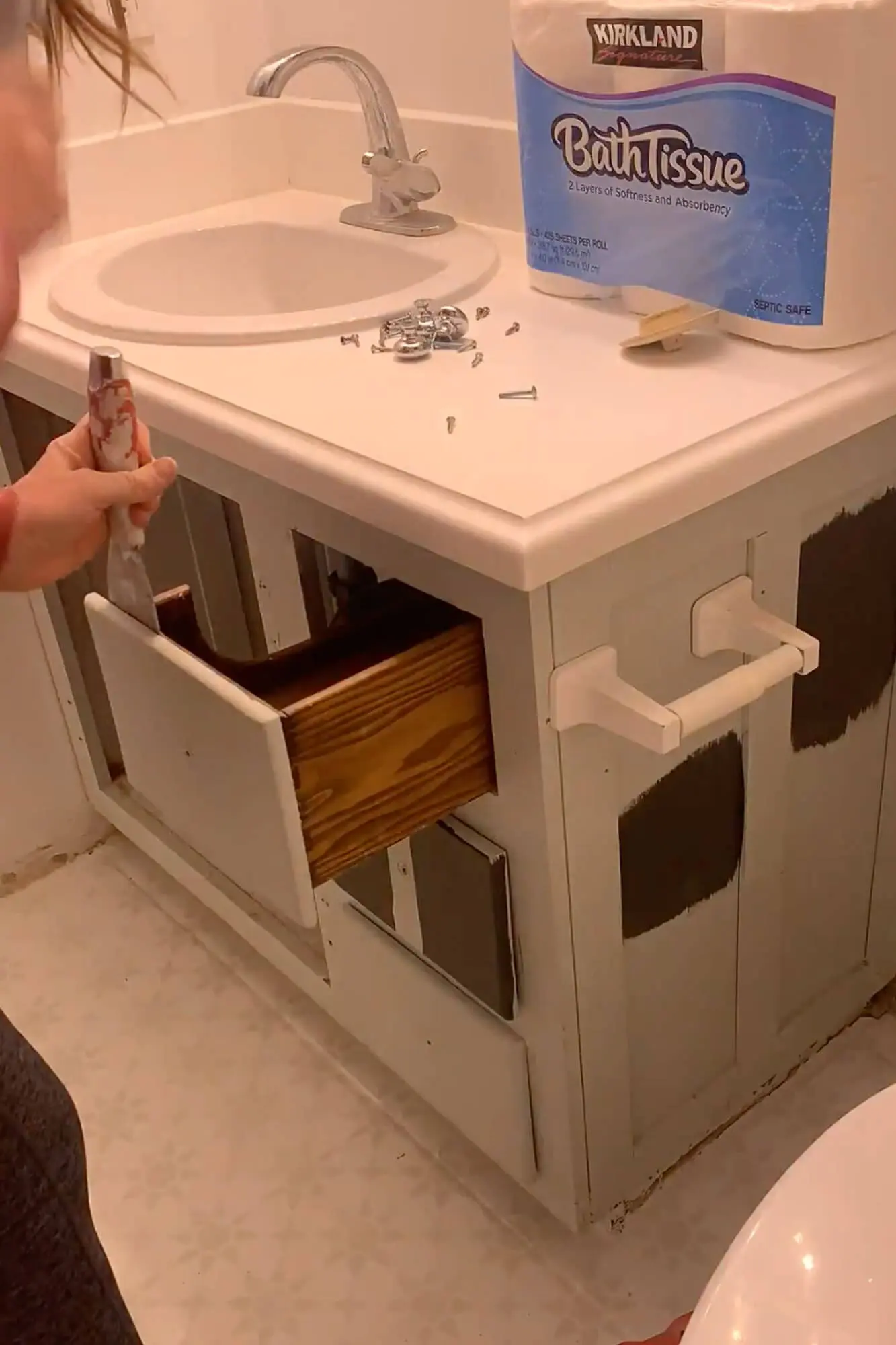 Removing a worn vanity drawer while prepping the cabinet frame for paint