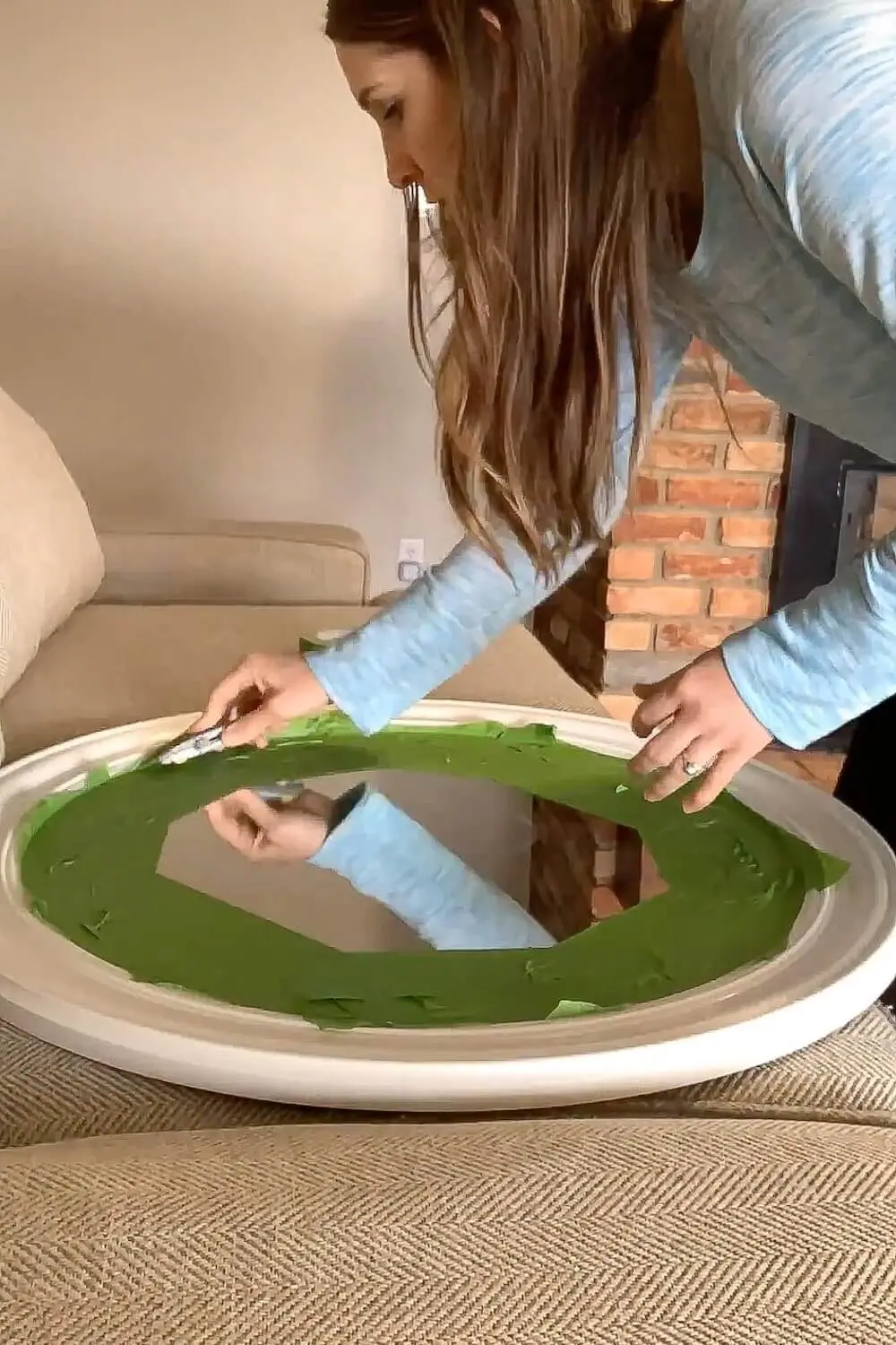 Painter’s tape covering mirror glass before painting the frame