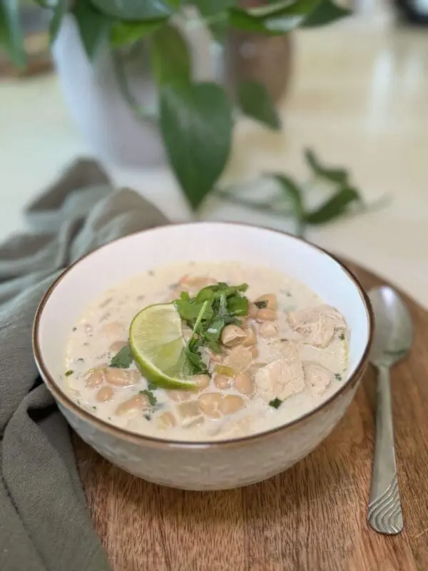 Creamy white chicken chili with lime and cilantro — a cozy and easy game day recipe idea.