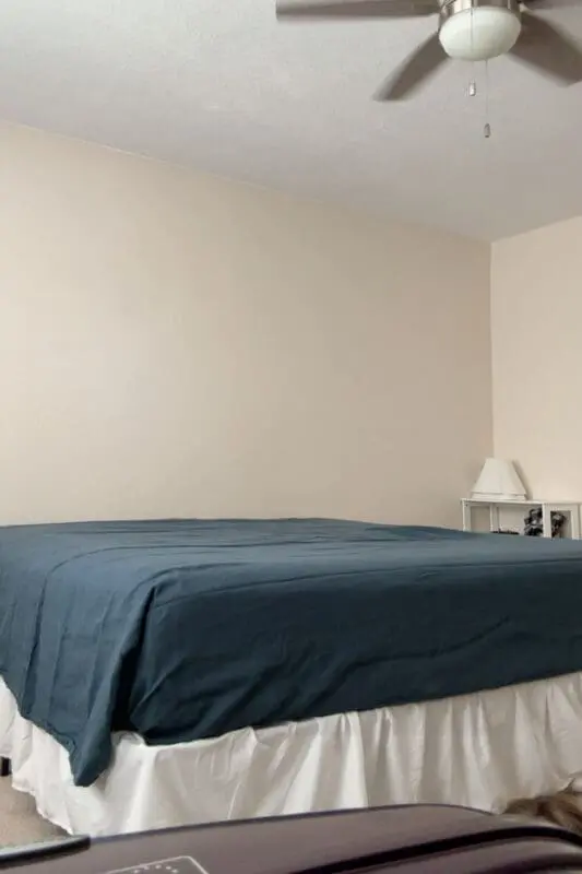 cozy fall bedding step with dark blue linen sheets smoothed over the guest bed before pillows and decor