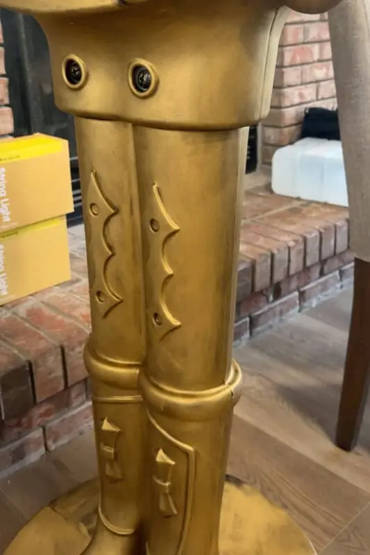 Close up of the legs on an antique bronze giant nutcracker, showing the smooth Rub n Buff finish before adding dark detail.