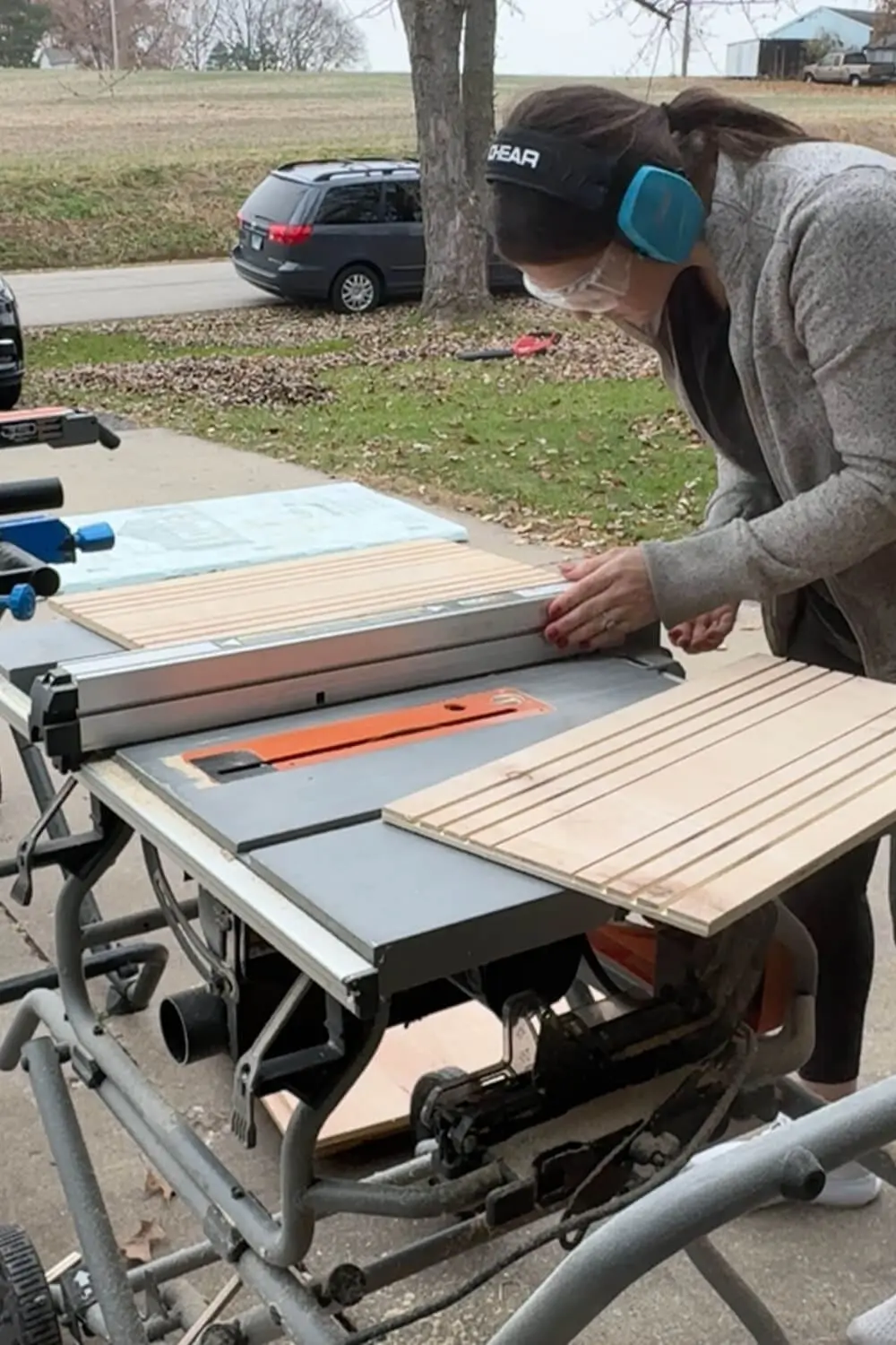 Ripping a plywood panel on the table saw to build a custom DIY sheet pan organizer for a lower kitchen cabinet