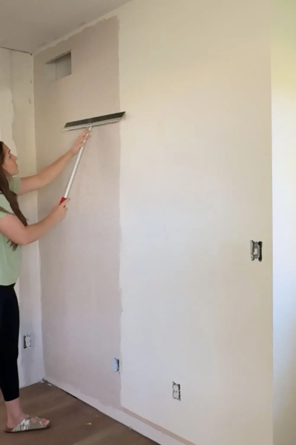 Skim coating a textured wall in preparation for adding picture frame molding.
