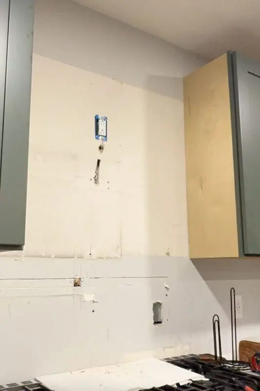 Wall space above the stove showing the newly installed outlet.