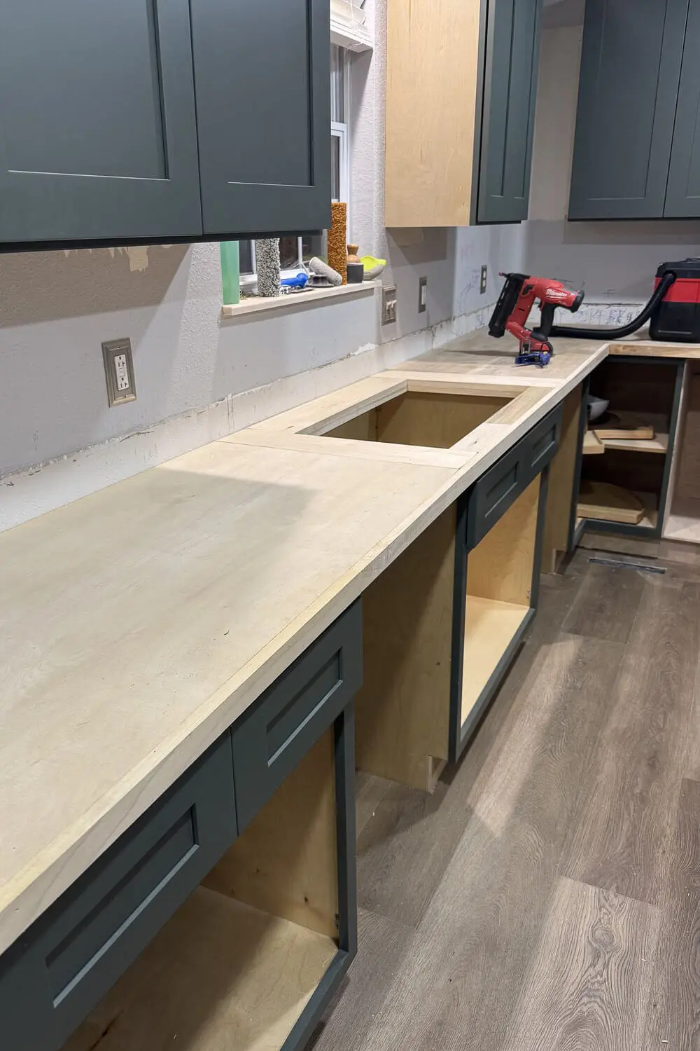 DIY plywood countertops installed and cut for the sink opening, ready for faux marble contact paper and an epoxy topcoat.
