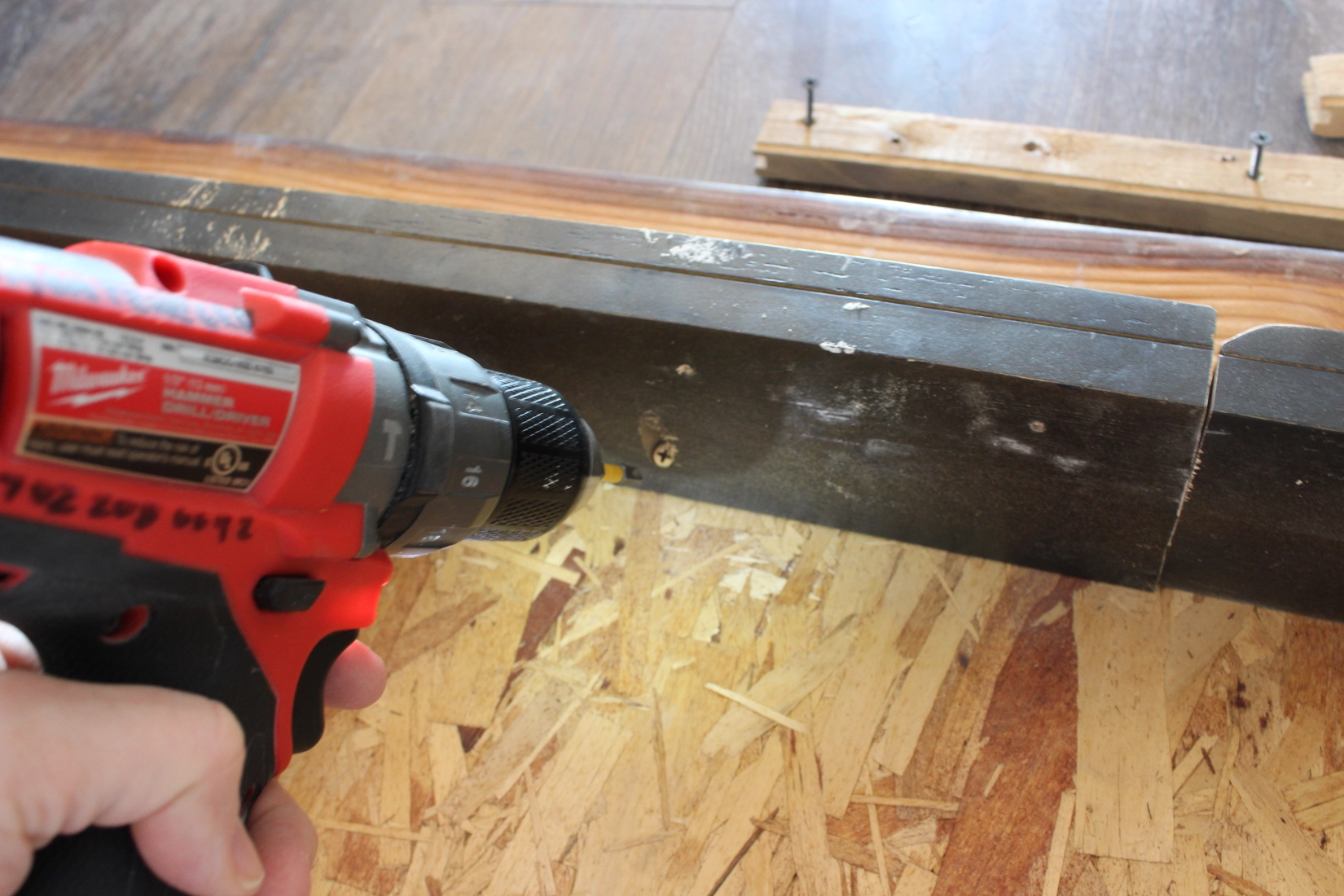 drilling a screw into wood
