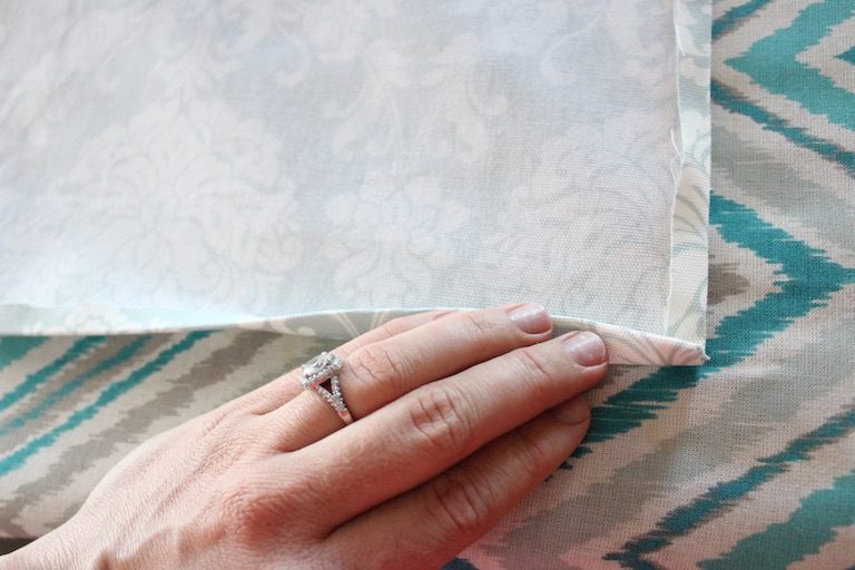 hand touching fabric square