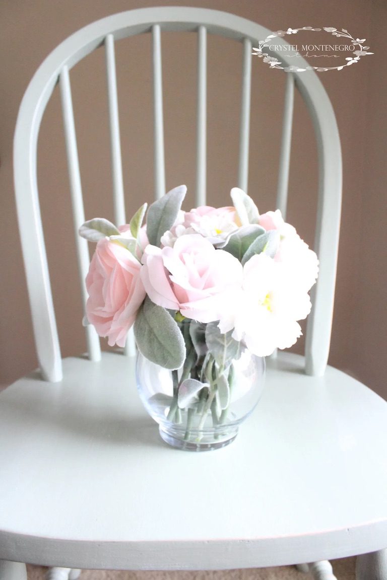 Flowers in a vase on a green chair