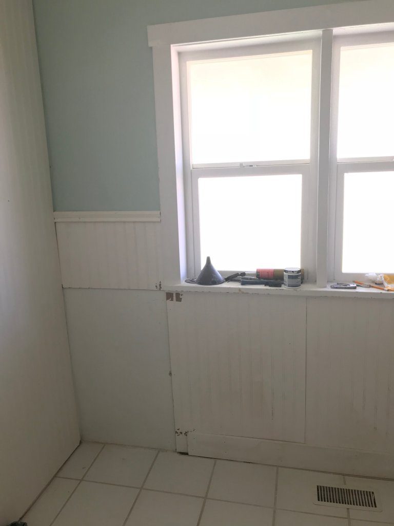 Wainscoting around a window in a bathroom