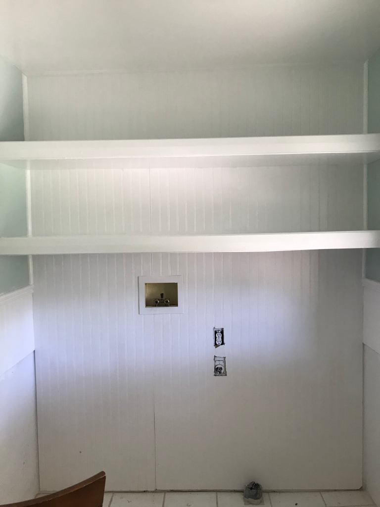 Floating shelves in laundry room