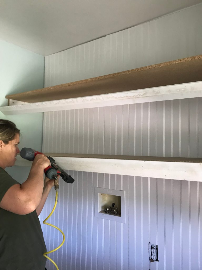 Nail gun in a laundry room for shelves