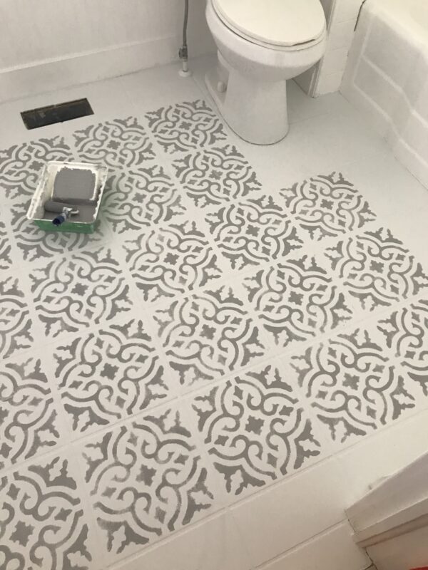 stencil on white tile floor