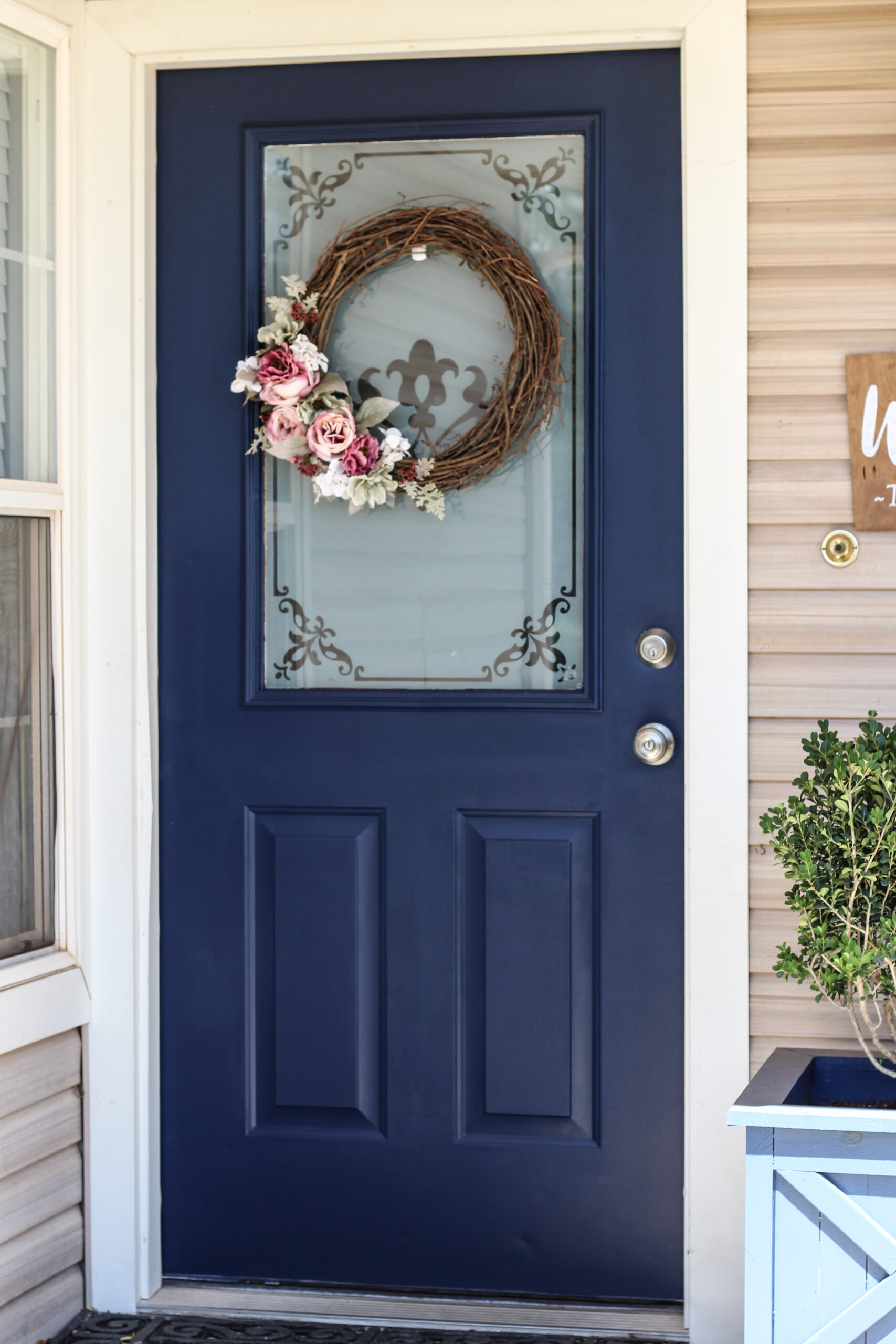 exterior door painted blue with wreath